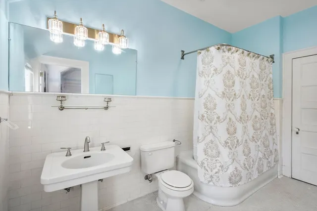 a bathroom with a sink toilet and mirror