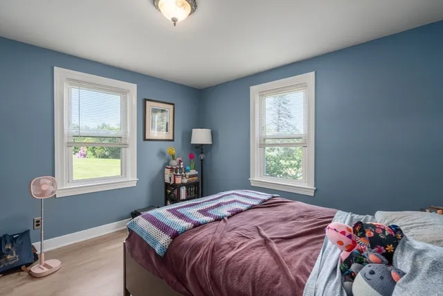 a bed sitting in a bedroom next to a window
