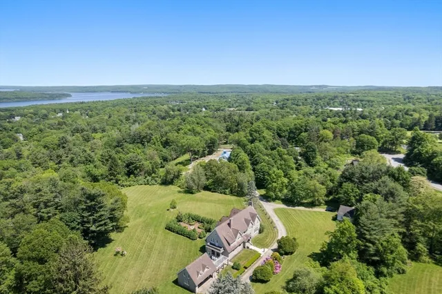 an aerial view of a houses with a yard