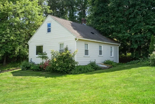 an aerial view of a house with garden space and street view