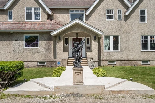 a front view of a house with garden