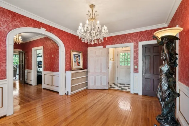 a view of a hallway with entryway wooden floor and chandelier