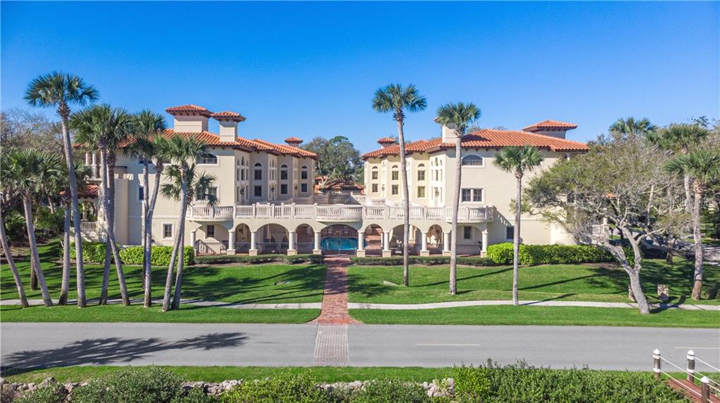 a view of a apartment with a yard and plants