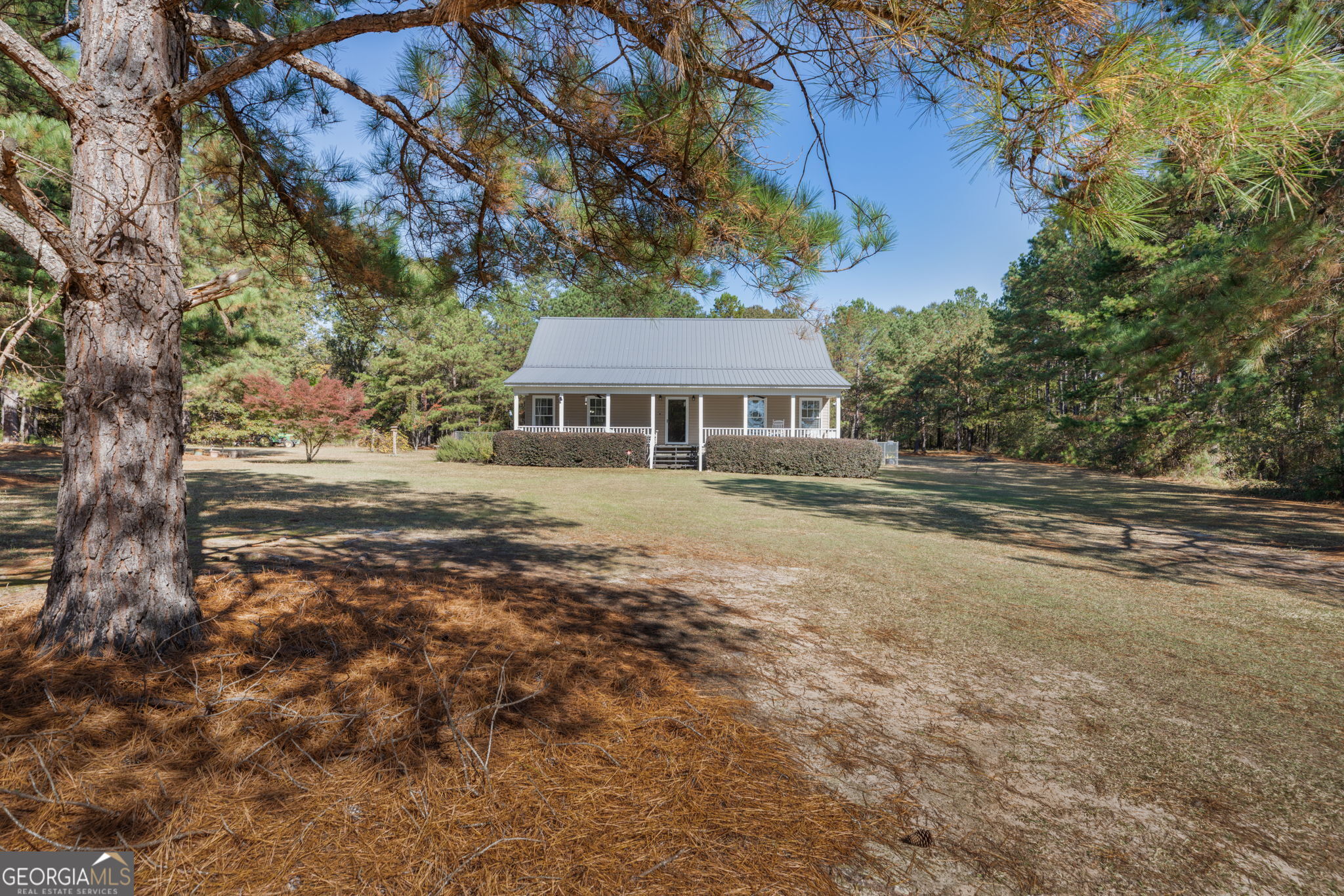 a view of a house with a yard and sitting area