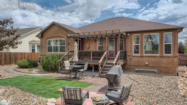 a front view of a house with sitting area