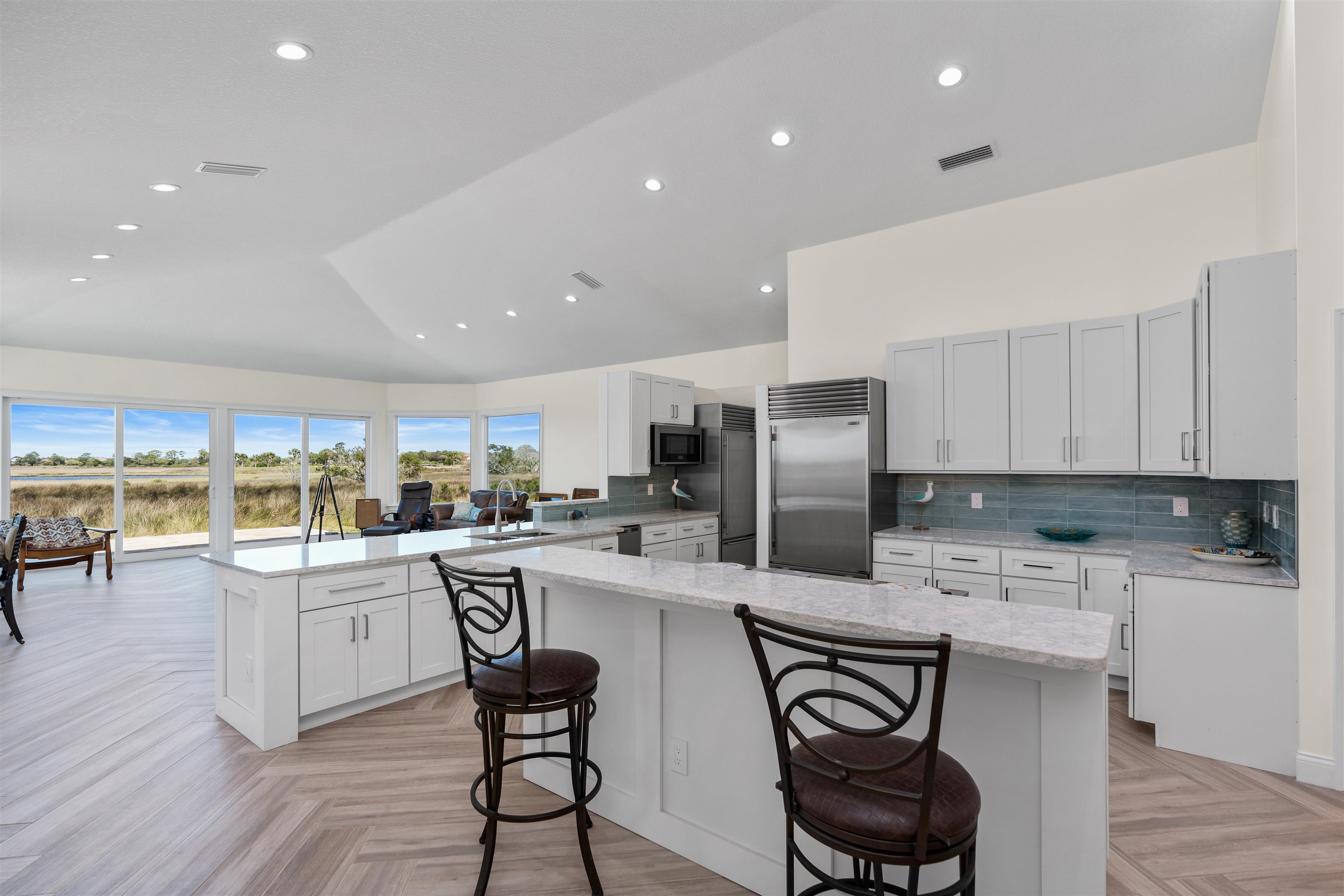 318 Marsh Point Circle St. Augustine, FL 32080 - Photo 15 of 44 a kitchen with stainless steel appliances granite countertop a table and chairs in it