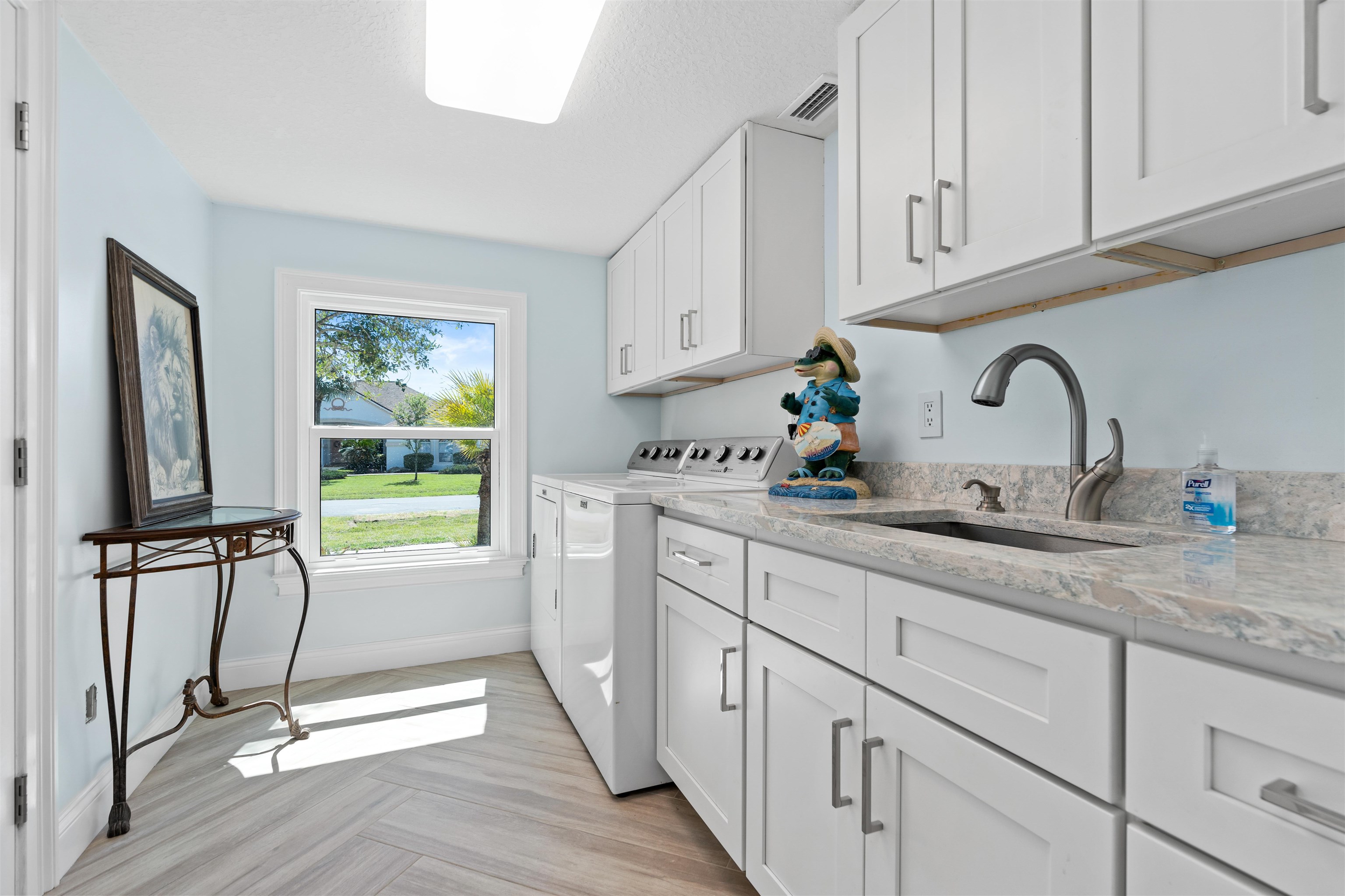 318 Marsh Point Circle St. Augustine, FL 32080 - Photo 34 of 44 a kitchen with kitchen island granite countertop a sink stainless steel appliances and cabinets