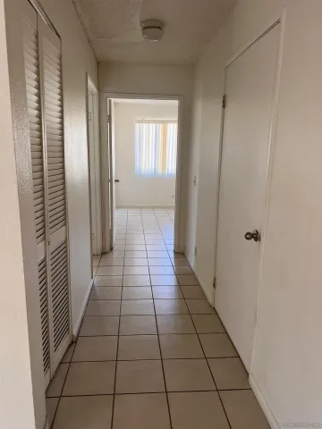 a hallway with a window and a mirror