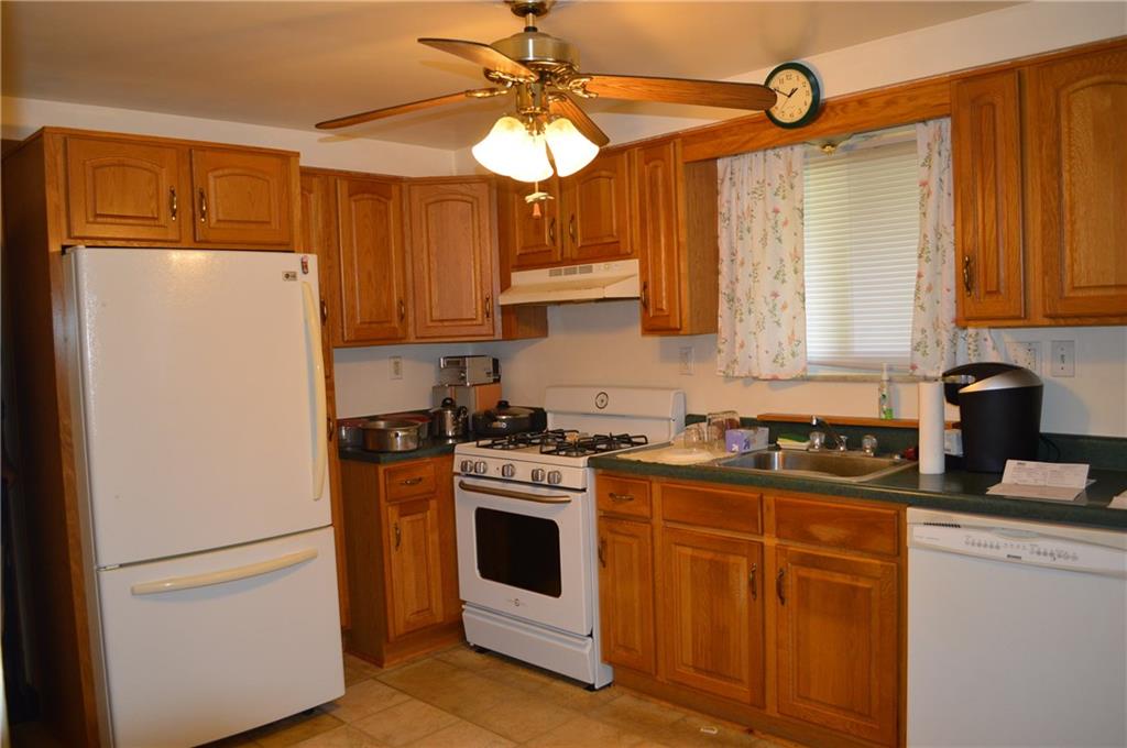 51 Gordon Street McKees Rocks, PA 15136 - Photo 3 of 6 a kitchen with stainless steel appliances granite countertop cabinets and a refrigerator