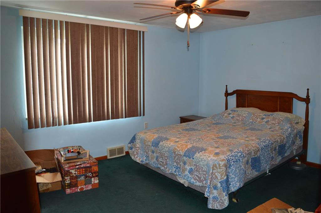 51 Gordon Street McKees Rocks, PA 15136 - Photo 4 of 6 a bedroom with a bed and a chandelier