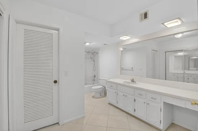 a spacious bathroom with a double vanity sink and a mirror