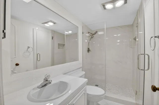 a bathroom with a sink toilet and shower