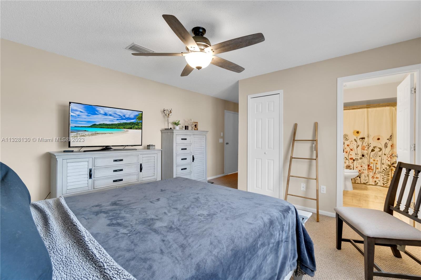 10274 Windswept Place Boca Raton, FL 33498 - Photo 17 of 33 a bedroom with a bed and a flat screen tv