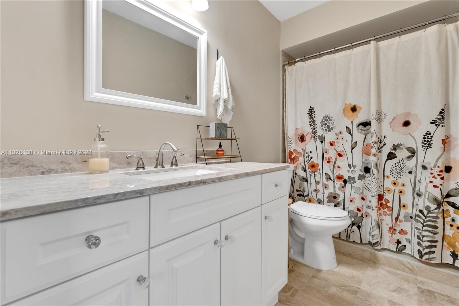 10274 Windswept Place Boca Raton, FL 33498 - Photo 18 of 33 a bathroom with a granite countertop sink a toilet and a mirror