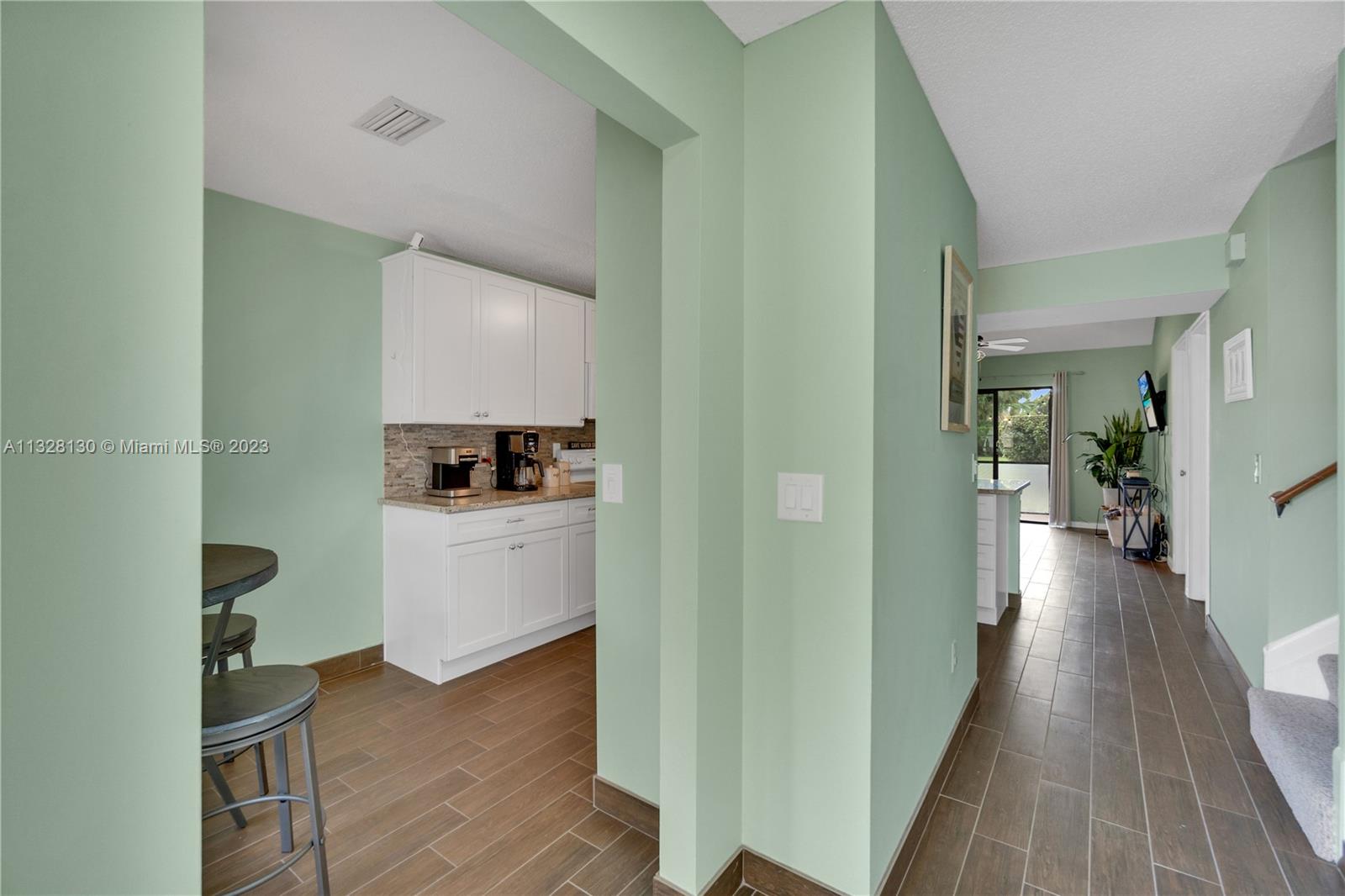 10274 Windswept Place Boca Raton, FL 33498 - Photo 2 of 33 a view of a hallway view with wooden floor and cabinets