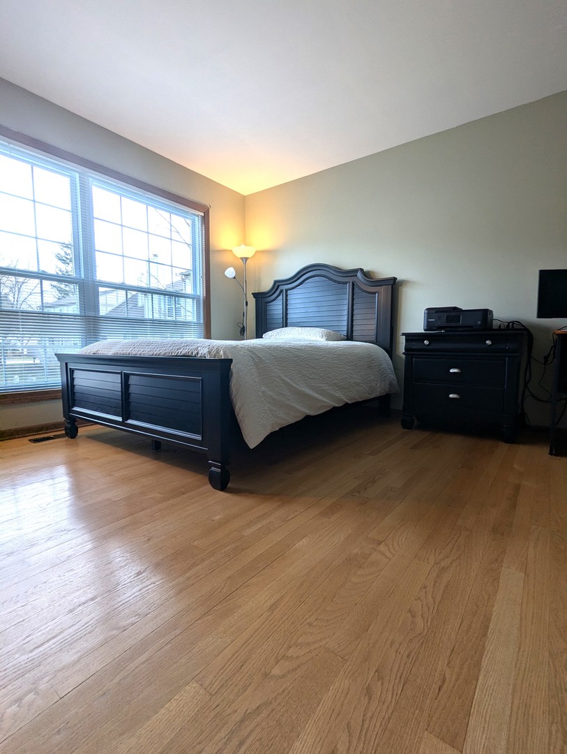 1466 Garnet Circle Hoffman Estates, IL 60192 - Photo 11 of 23 a bedroom with a bed and window