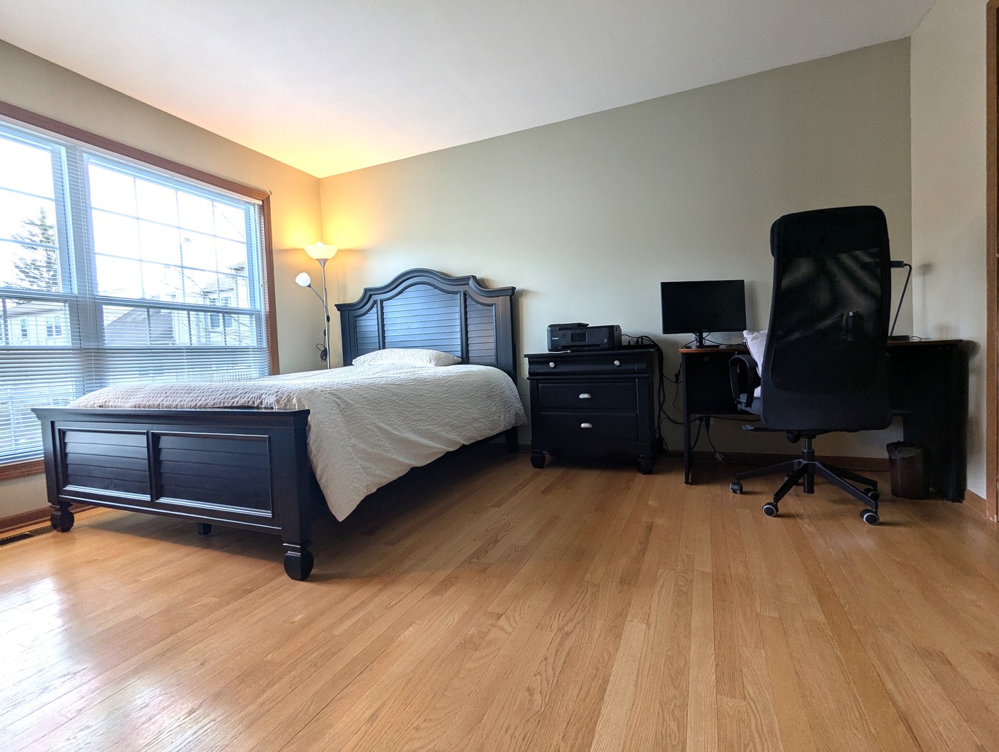 1466 Garnet Circle Hoffman Estates, IL 60192 - Photo 12 of 23 a bedroom with a bed and wooden floor