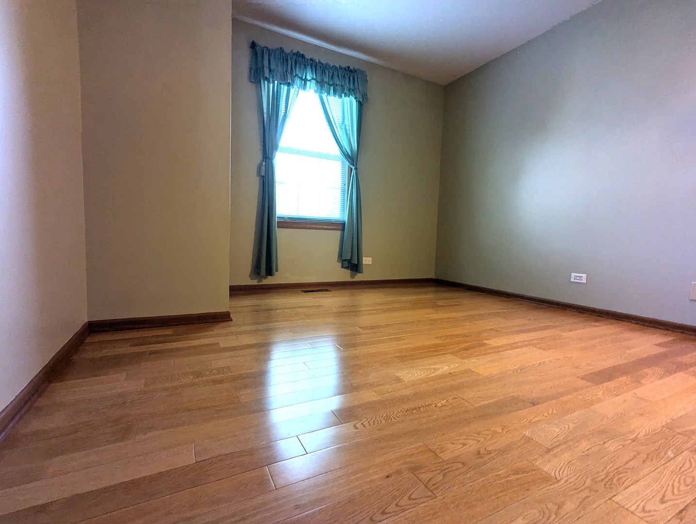 1466 Garnet Circle Hoffman Estates, IL 60192 - Photo 15 of 23 an empty room with wooden floor and windows