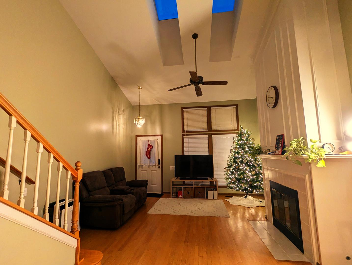 1466 Garnet Circle Hoffman Estates, IL 60192 - Photo 2 of 23 a living room with furniture a fireplace and a flat screen tv