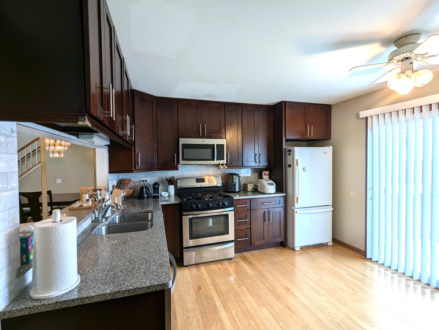 1466 Garnet Circle Hoffman Estates, IL 60192 - Photo 4 of 23 a kitchen with stainless steel appliances granite countertop a sink stove and refrigerator