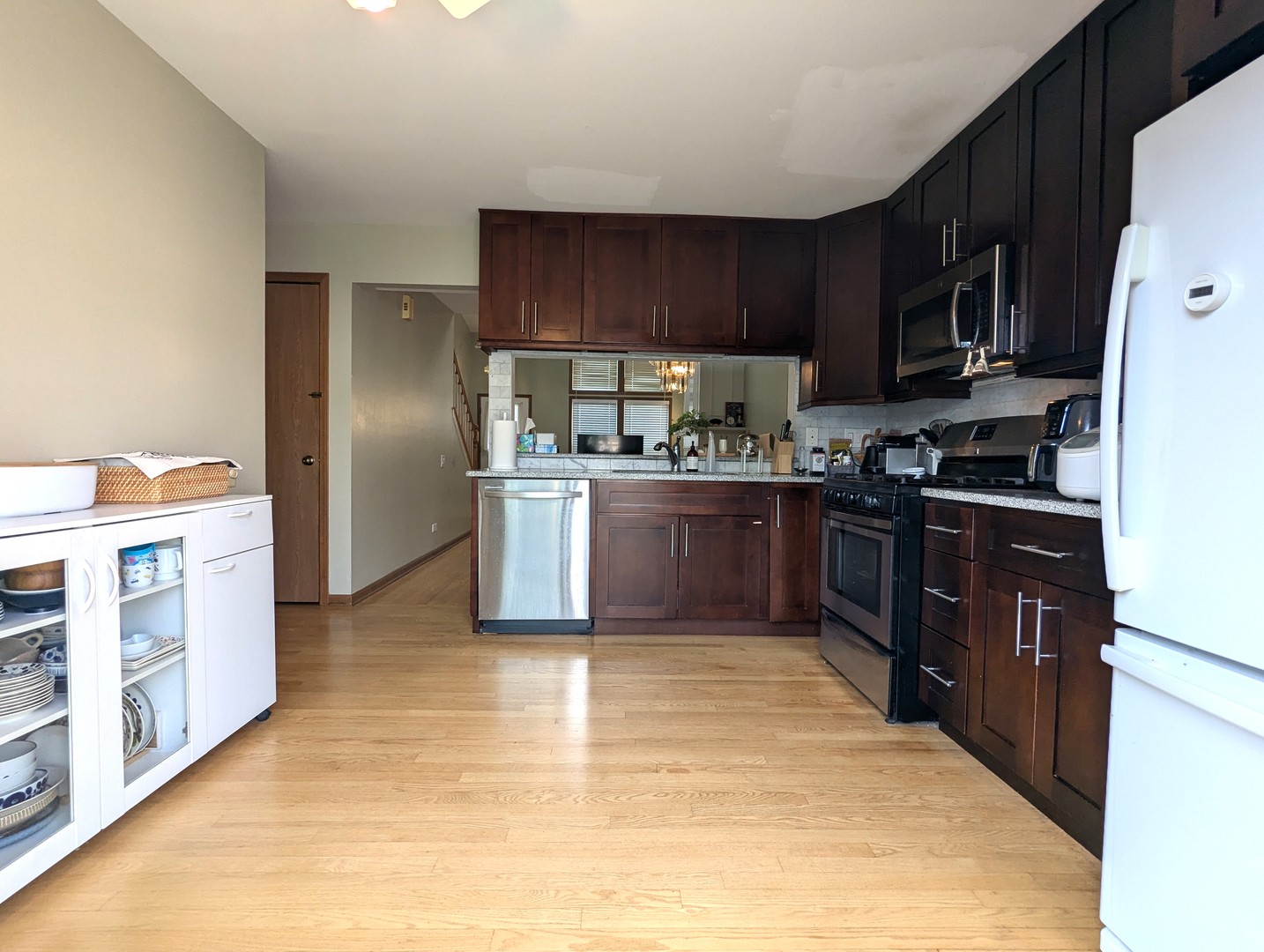1466 Garnet Circle Hoffman Estates, IL 60192 - Photo 5 of 23 a kitchen with stainless steel appliances granite countertop a stove top oven a sink dishwasher and a refrigerator