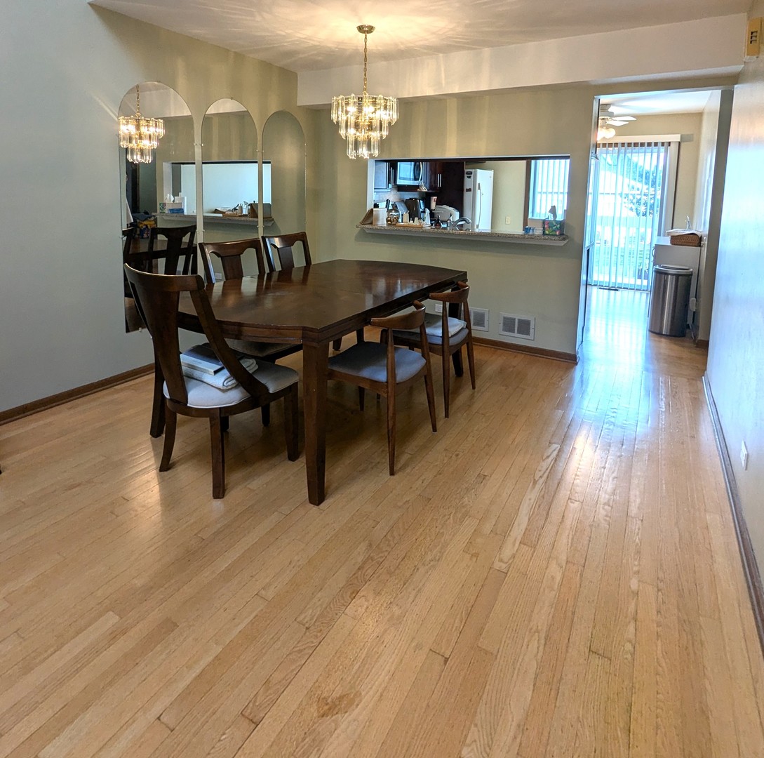 1466 Garnet Circle Hoffman Estates, IL 60192 - Photo 6 of 23 a view of a dining room with furniture and wooden floor