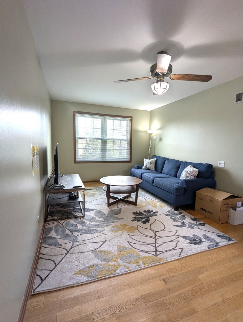 1466 Garnet Circle Hoffman Estates, IL 60192 - Photo 10 of 23 a living room with furniture and a chandelier