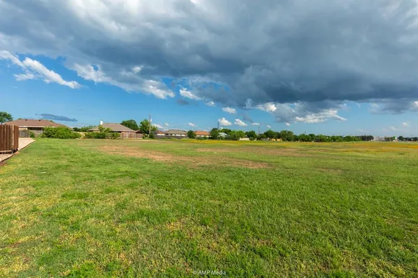 a view of yard with ocean and mountain in the background