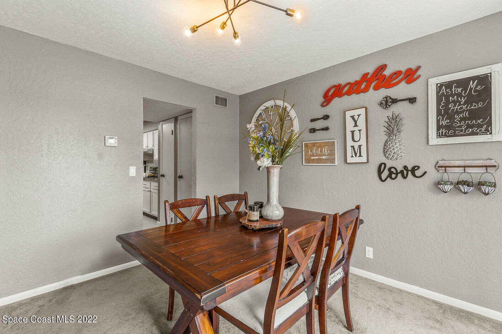 1784 Quail Trail Melbourne, FL 32935 - Photo 23 of 40 a dining room with a table and chairs