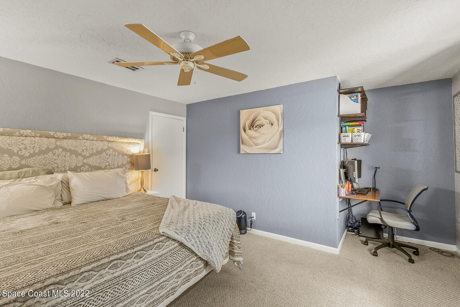 1784 Quail Trail Melbourne, FL 32935 - Photo 26 of 40 a bedroom with a bed and a desk