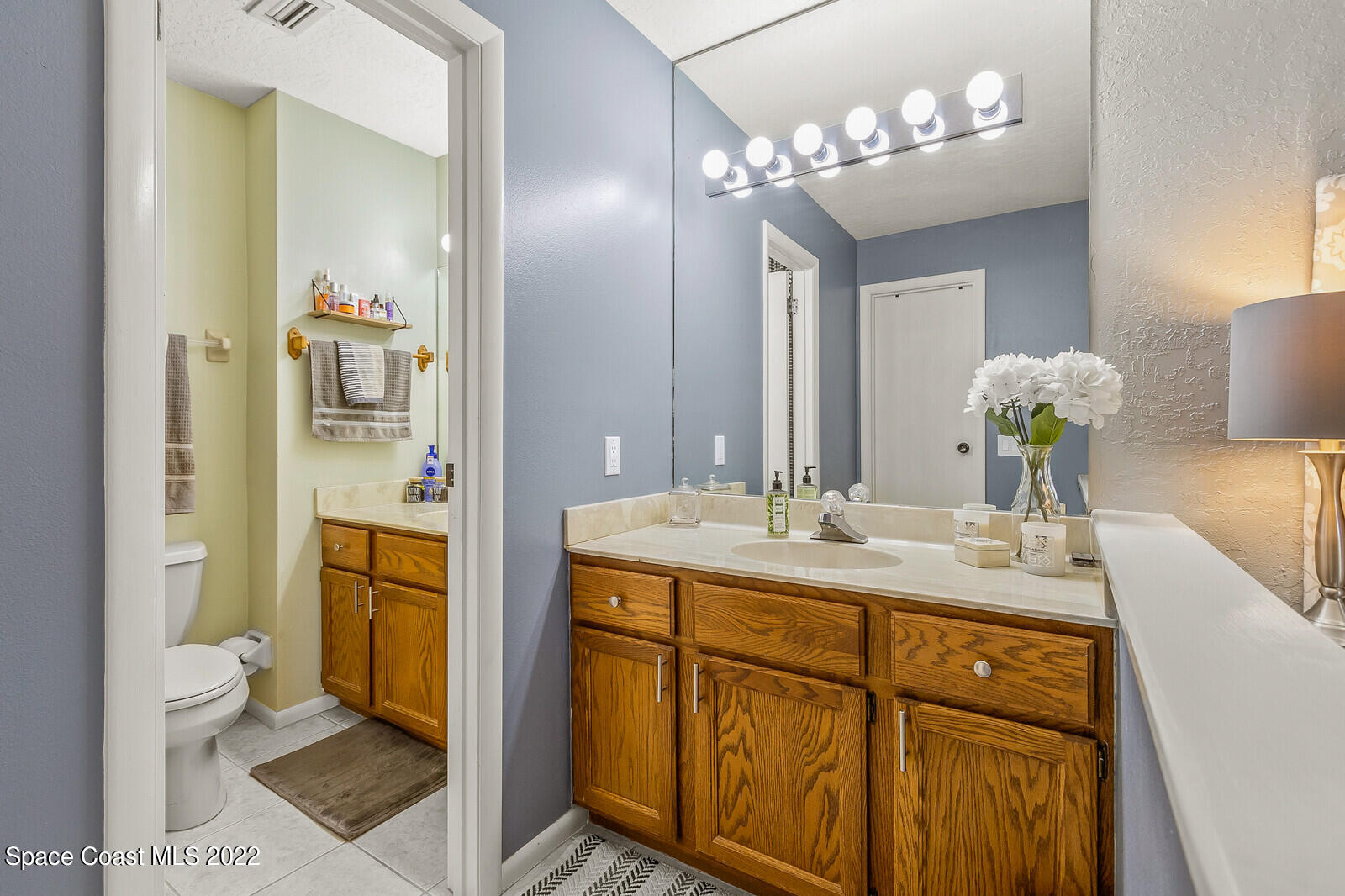 1784 Quail Trail Melbourne, FL 32935 - Photo 27 of 40 a bathroom with a sink a toilet and shower