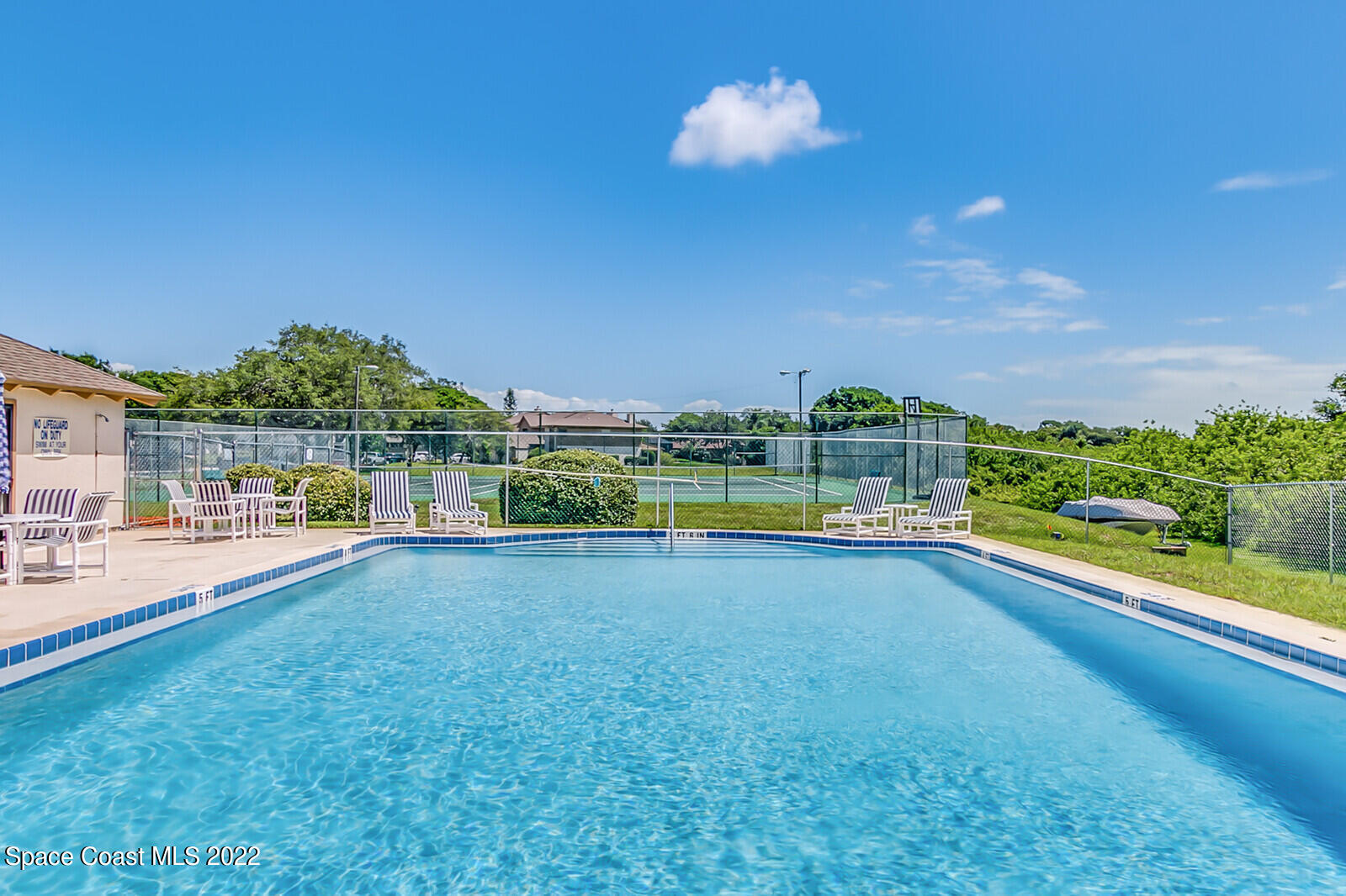 1784 Quail Trail Melbourne, FL 32935 - Photo 38 of 40 a view of a swimming pool with an outdoor seating and a garden