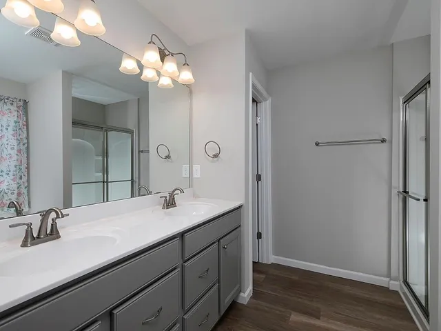 a bathroom with a sink a light fixture and a mirror