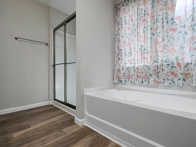 a bathroom with a bathtub and shower