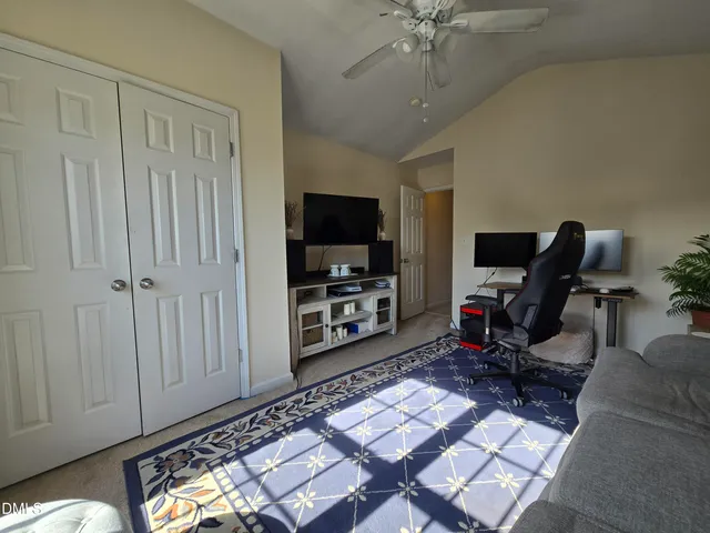 a room with furniture a flat screen tv and a window