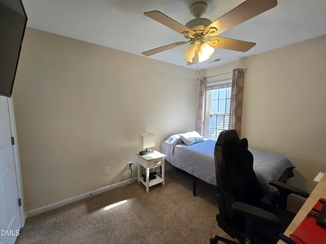 a bedroom with bed and a chandelier