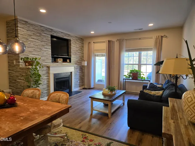 a living room with furniture a fireplace and a flat screen tv