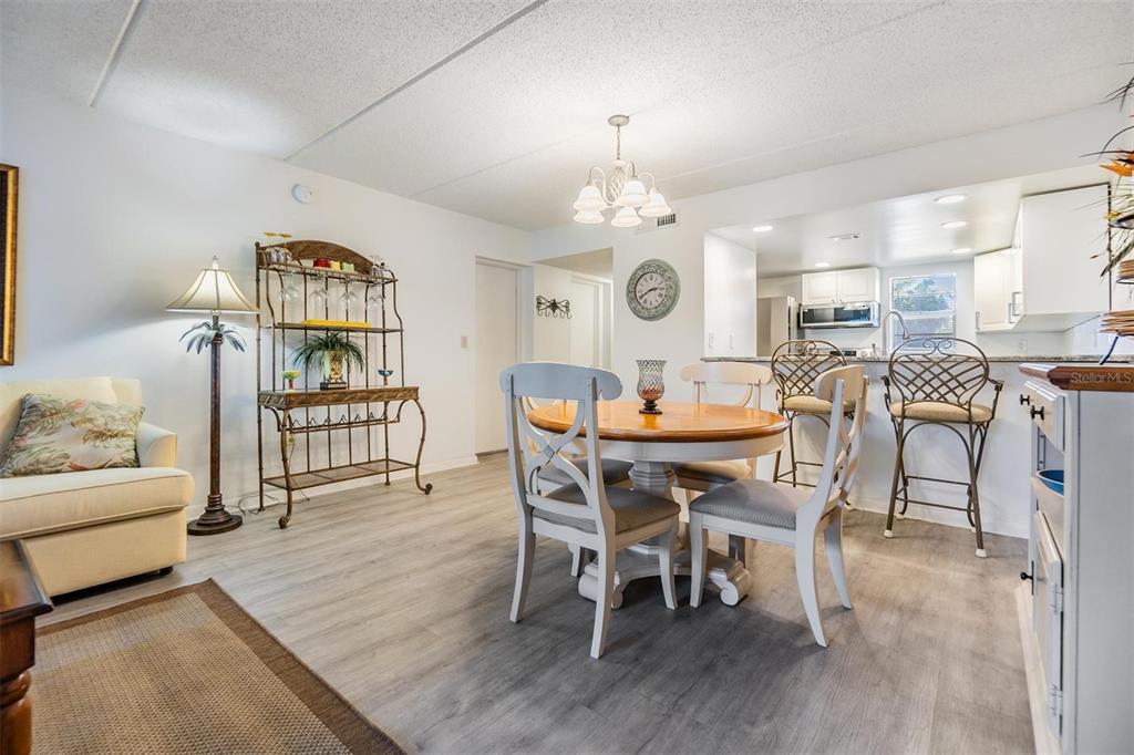 12760 Indian Rocks Road, Unit 104 Largo, FL 33774 - Photo 10 of 37 a view of a dining room with furniture and wooden floor