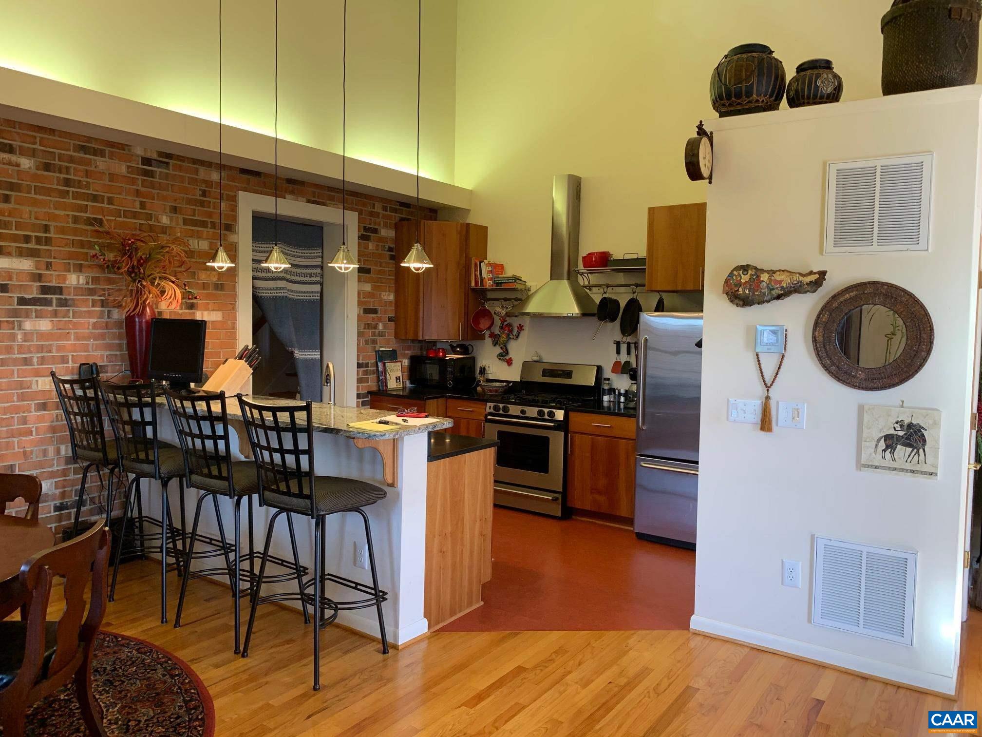 5305 Hoover Road Reva, VA 22735 - Photo 11 of 46 a kitchen with stainless steel appliances kitchen island granite countertop a table and chairs in it