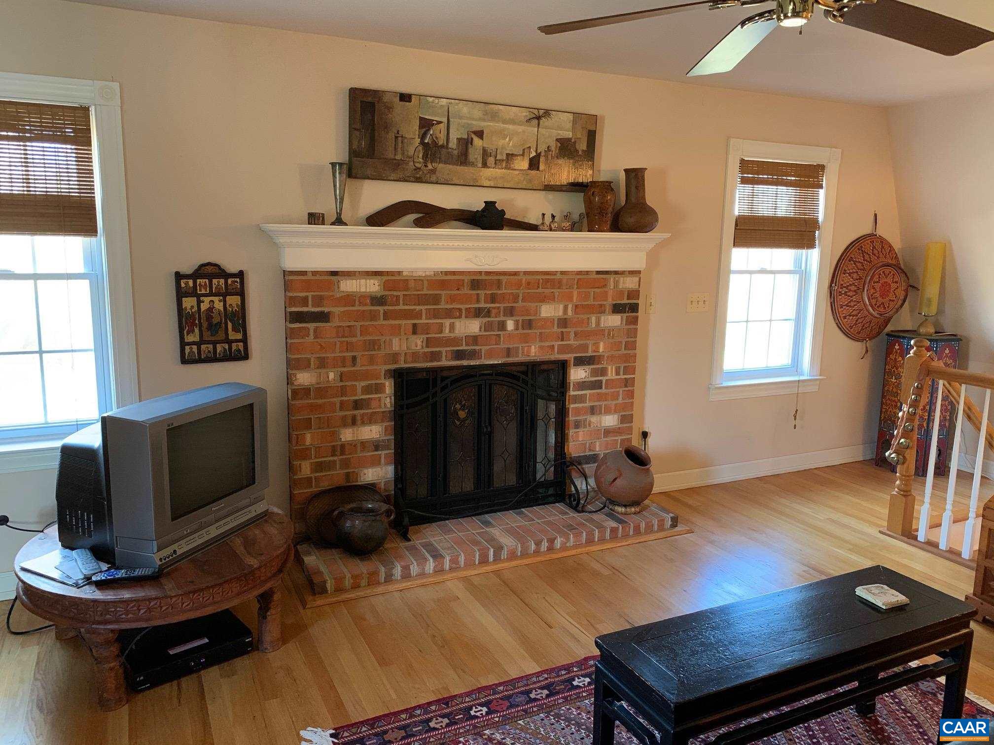 5305 Hoover Road Reva, VA 22735 - Photo 22 of 46 a living room with furniture a fireplace and a flat screen tv
