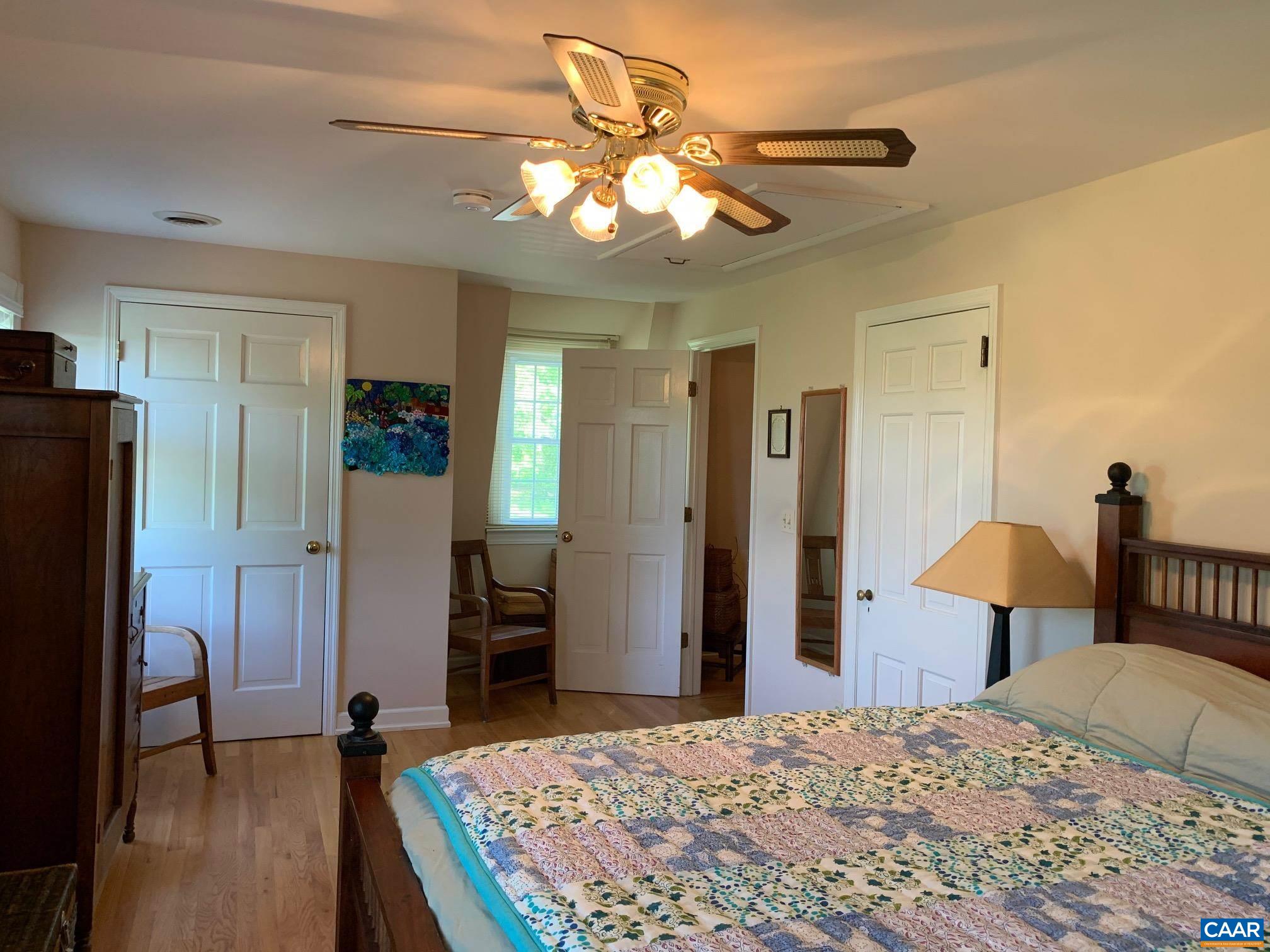 5305 Hoover Road Reva, VA 22735 - Photo 33 of 46 a bedroom with a bed and a chandelier