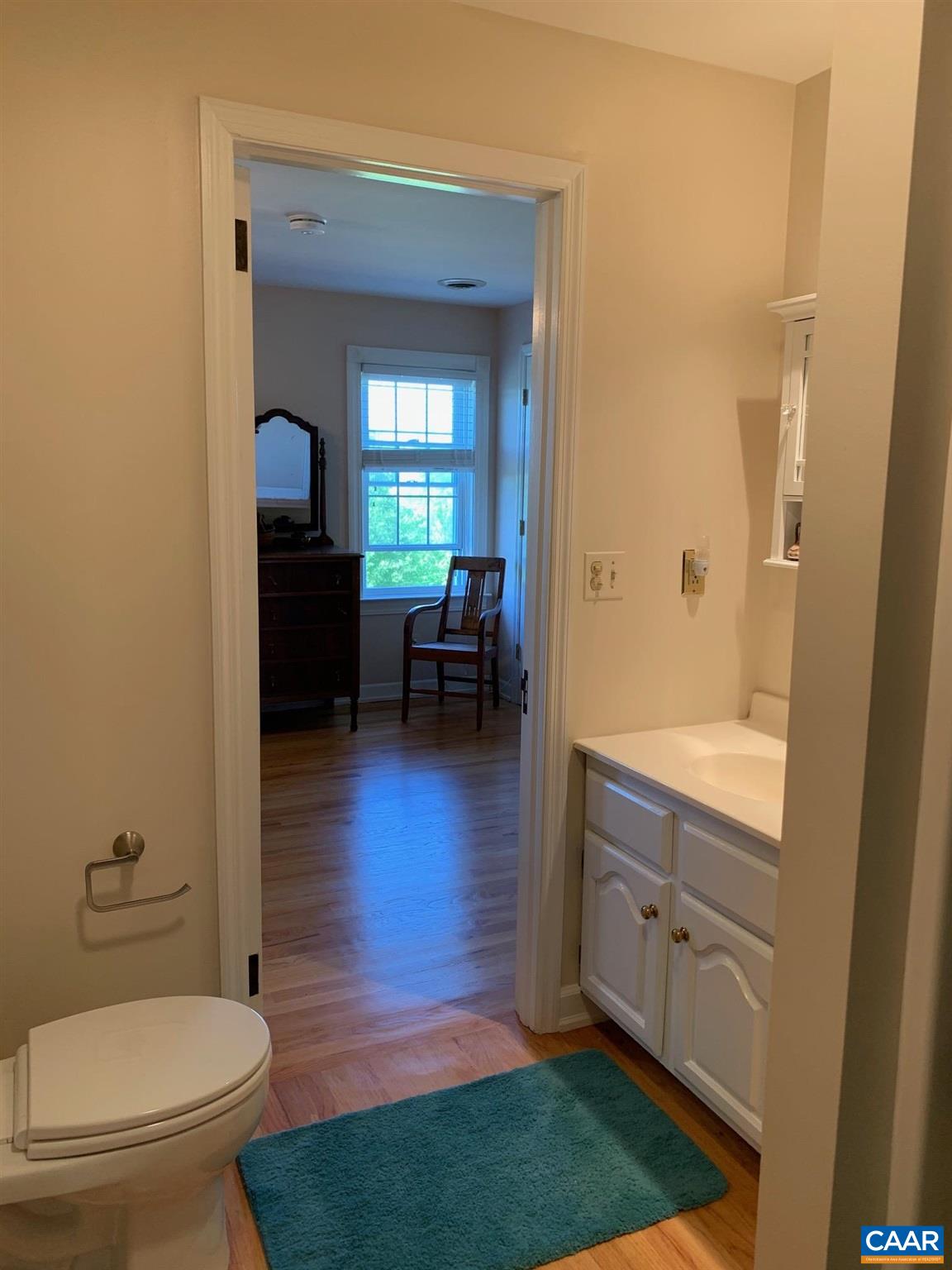 5305 Hoover Road Reva, VA 22735 - Photo 36 of 46 a bathroom with a toilet a sink a mirror and a window