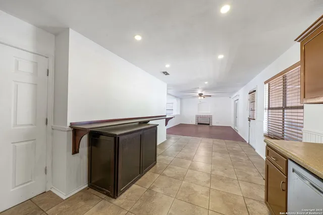 a kitchen with stainless steel appliances granite countertop a sink counter space cabinets and a large window