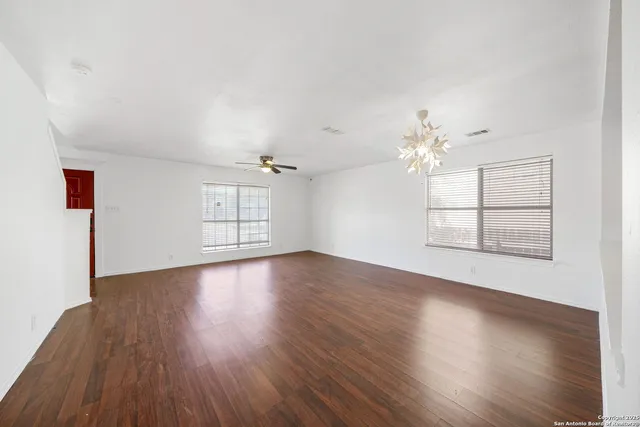 wooden floor in an empty room with a window