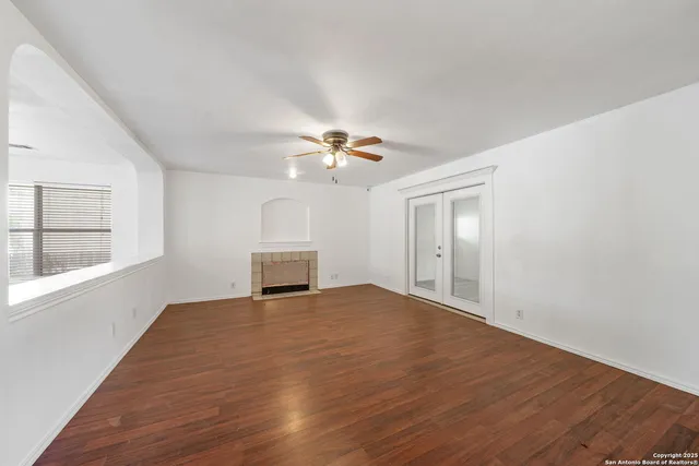 a view of a livingroom with a ceiling fan and window