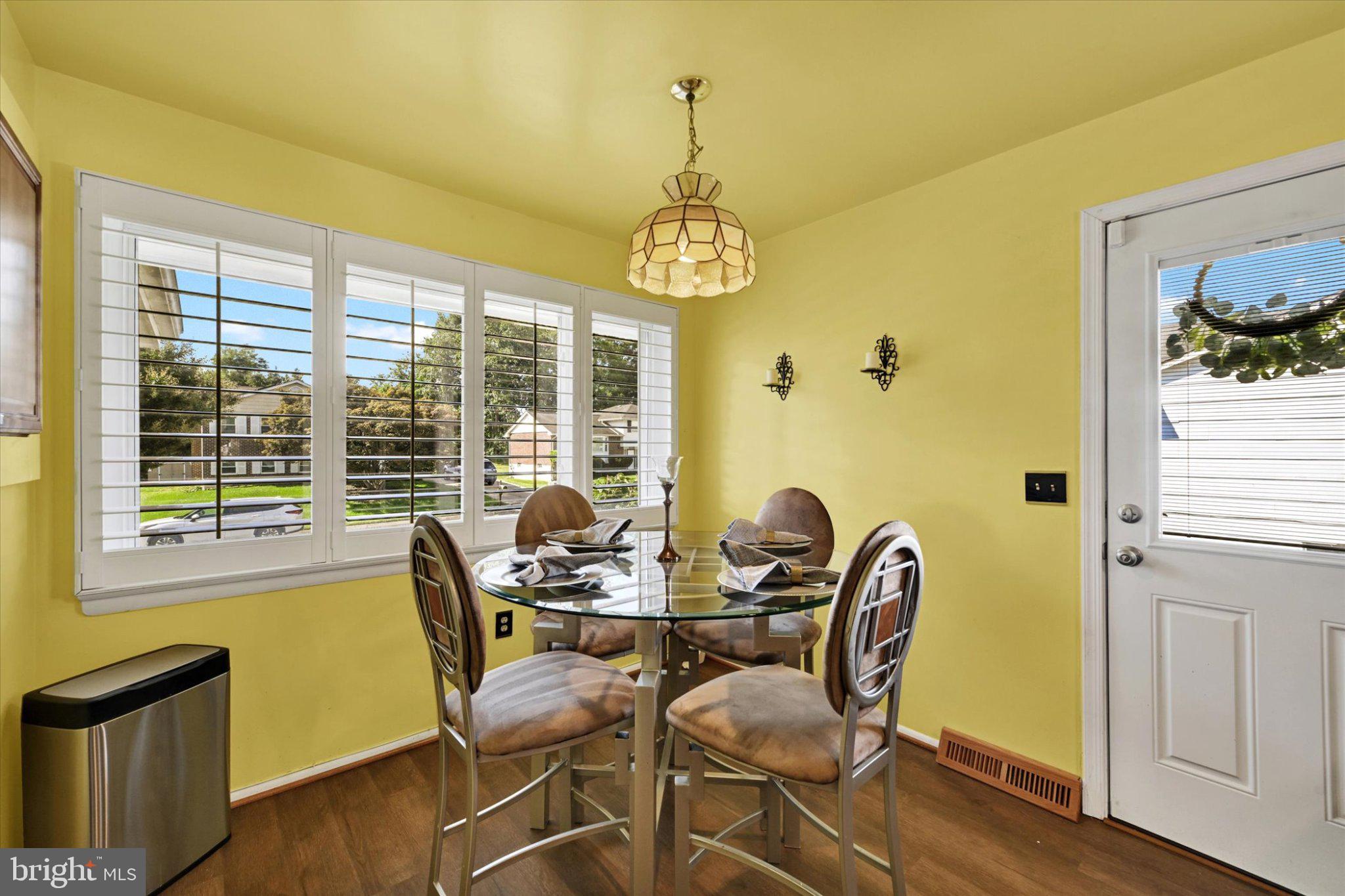 9704 Eustice Road Randallstown, MD 21133 - Photo 12 of 43 Sunny dining nook with vibrant yellow walls.