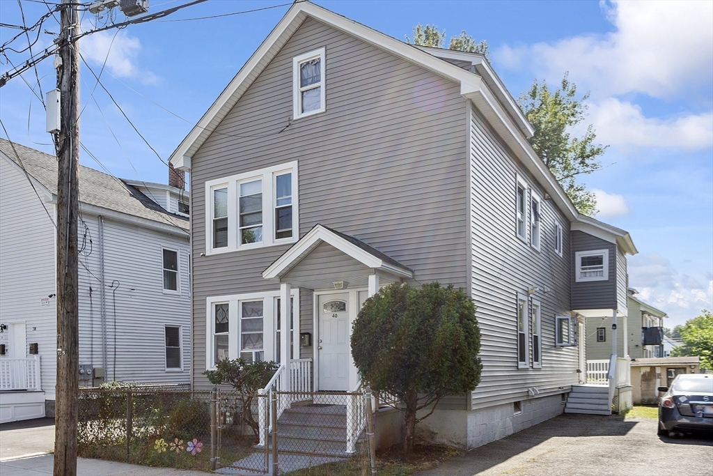 42 Perry Avenue, Unit 2 Lawrence, MA 01841 - Photo 2 of 8 a view of a house with a yard and sitting area