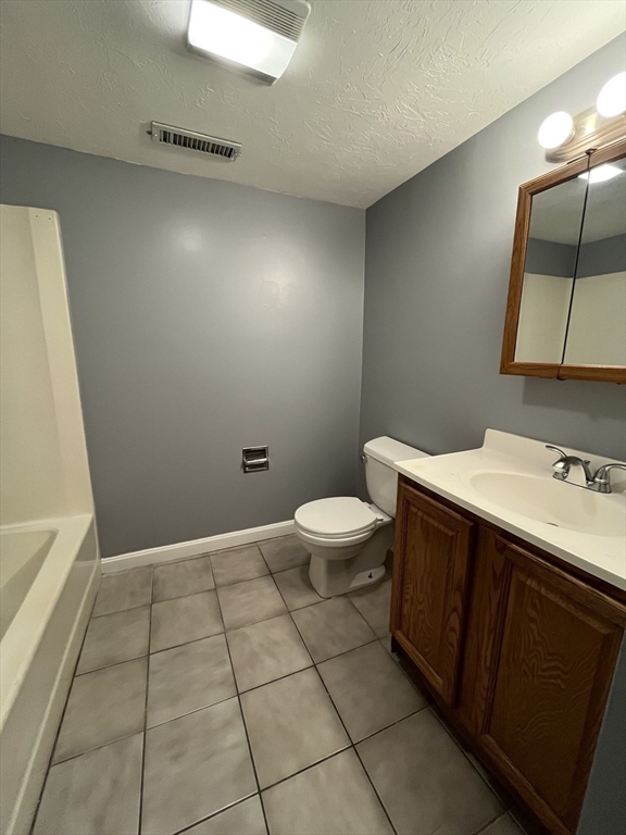 120 15th Street, Unit 4 Fall River, MA 02723 - Photo 5 of 8 a bathroom with a sink a toilet and mirror