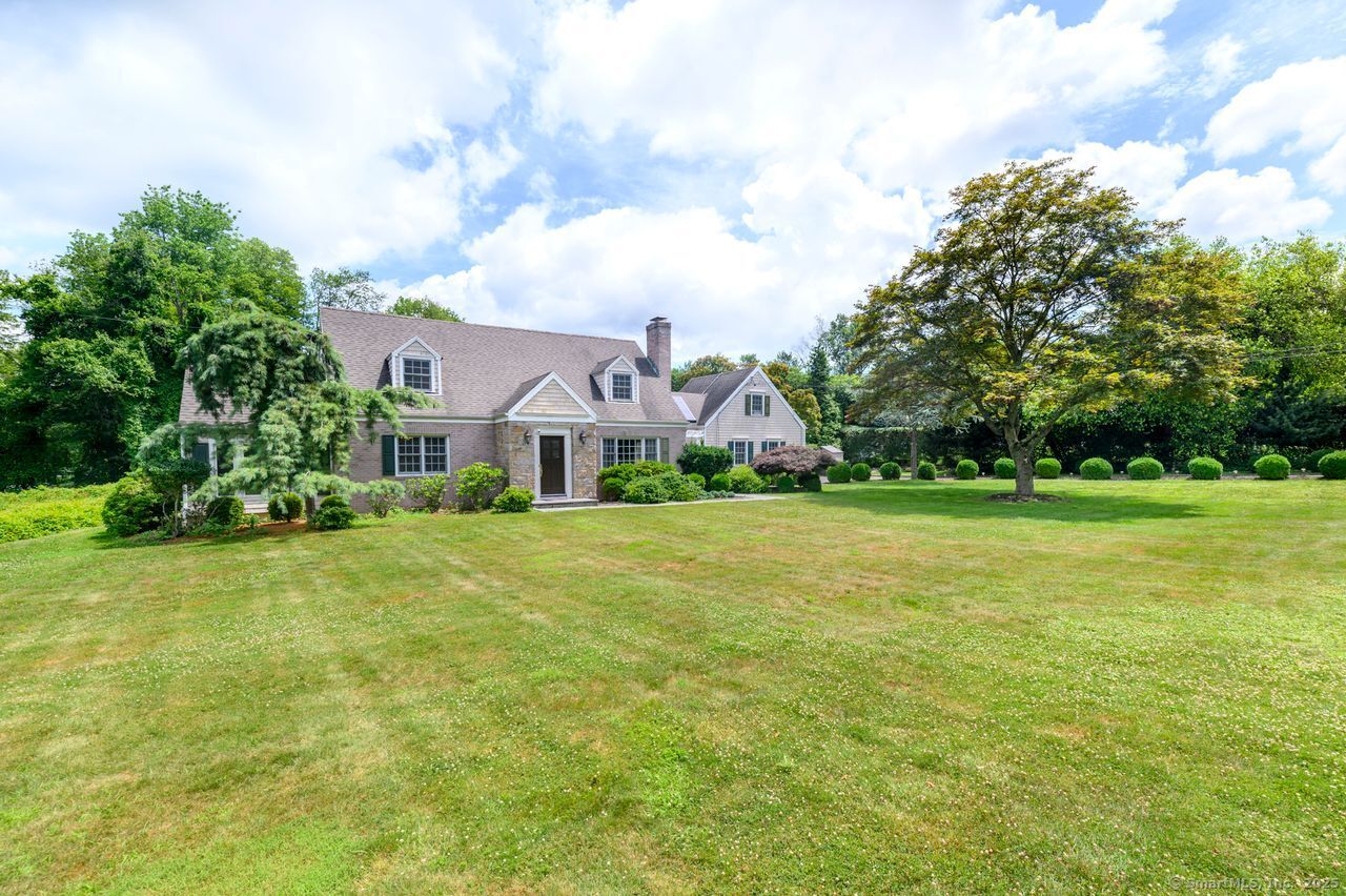 a front view of house with yard and green space