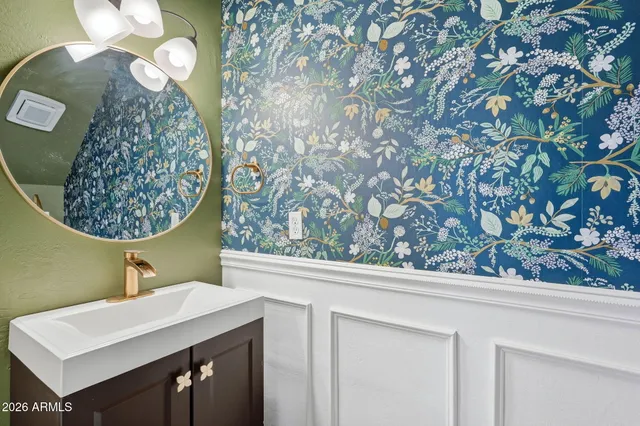 a bathroom with a sink mirror vanity and toilet